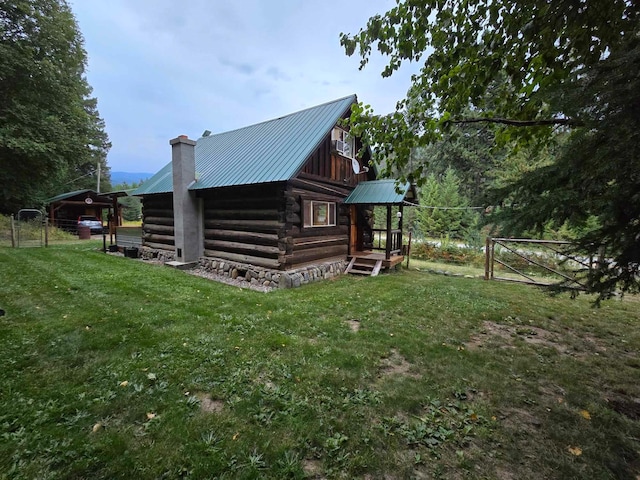 view of property exterior with an outdoor structure and a lawn