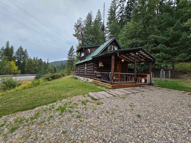 exterior space featuring a lawn and a wooden deck