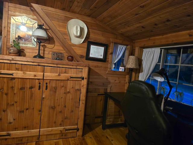 office area featuring vaulted ceiling, wood walls, hardwood / wood-style floors, and wooden ceiling