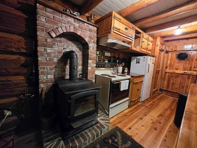 kitchen featuring ventilation hood, wooden ceiling, light hardwood / wood-style flooring, white appliances, and a wood stove