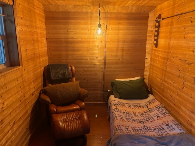 bedroom with wood ceiling and wood walls