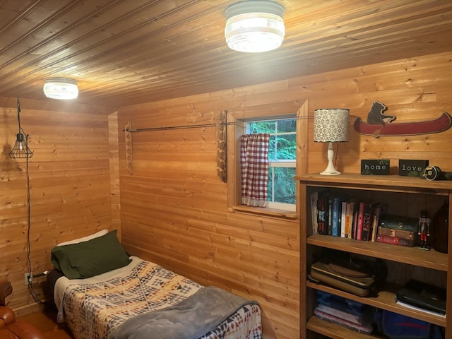 bedroom featuring wooden walls and wooden ceiling