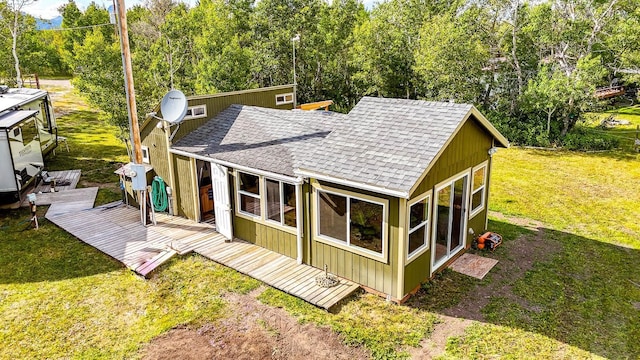 back of house featuring a yard and a deck