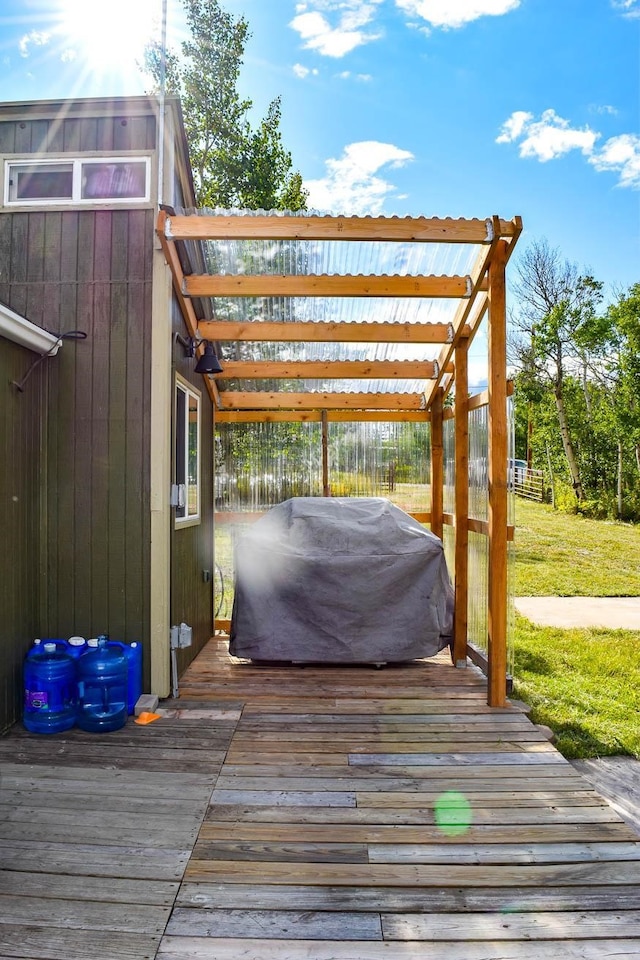 wooden terrace featuring a pergola and a grill