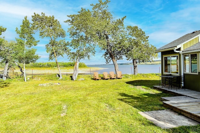 view of yard featuring a deck with water view