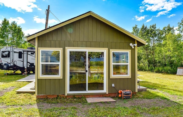 rear view of house featuring a yard