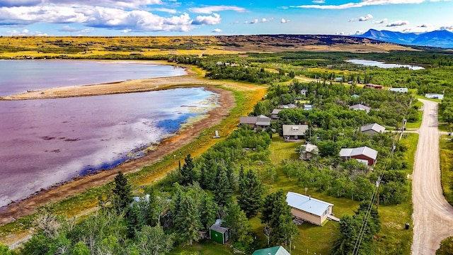 drone / aerial view featuring a water and mountain view