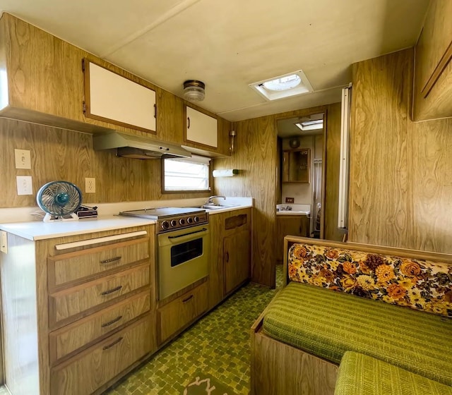 kitchen with oven, sink, and electric stove