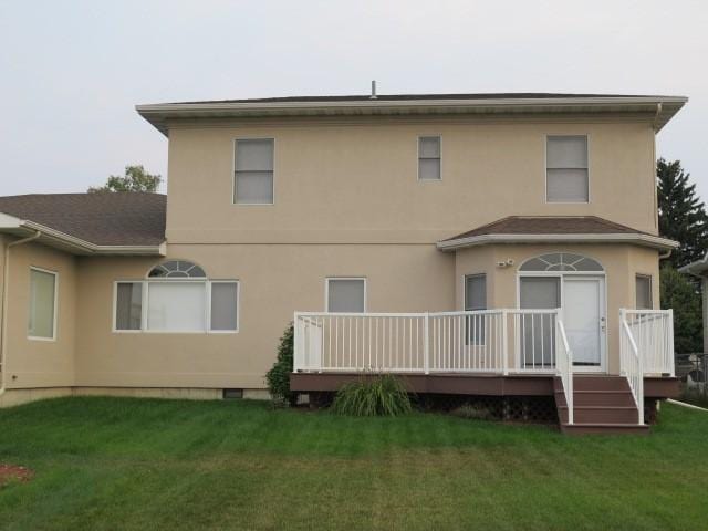 back of property featuring a yard and a deck