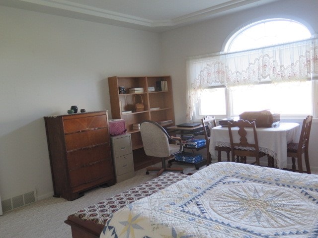 bedroom featuring light carpet