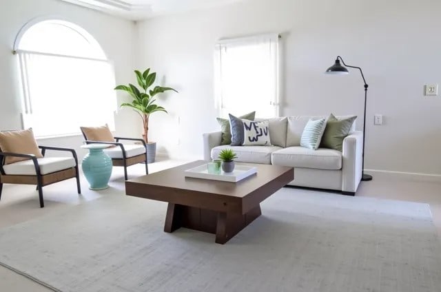 living area featuring a wealth of natural light and baseboards