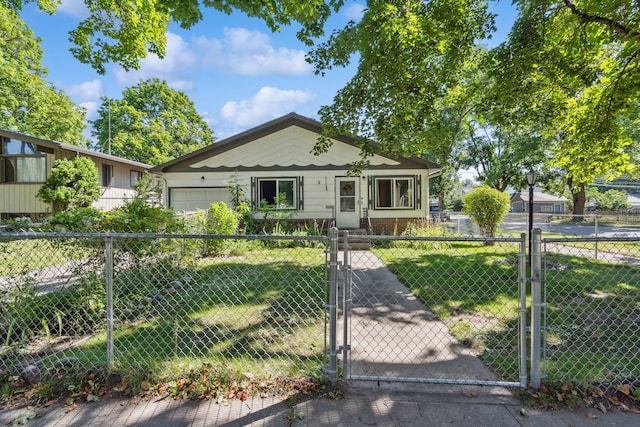 bungalow featuring a front lawn and a garage