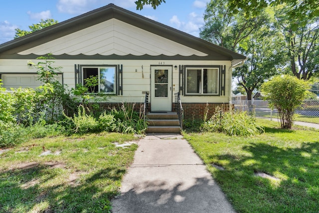 bungalow-style home featuring a front yard