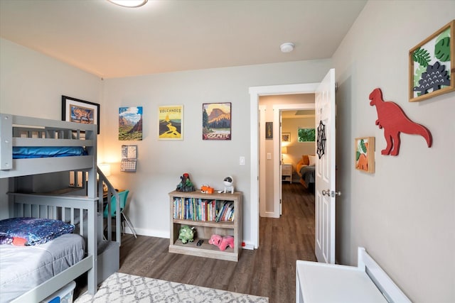 bedroom with baseboards and wood finished floors