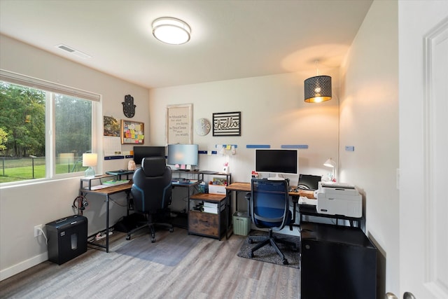 home office with visible vents, baseboards, and wood finished floors