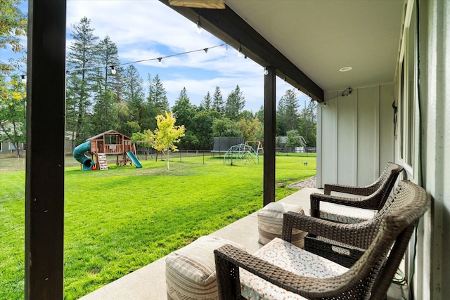 exterior space featuring a playground, fence, and a trampoline