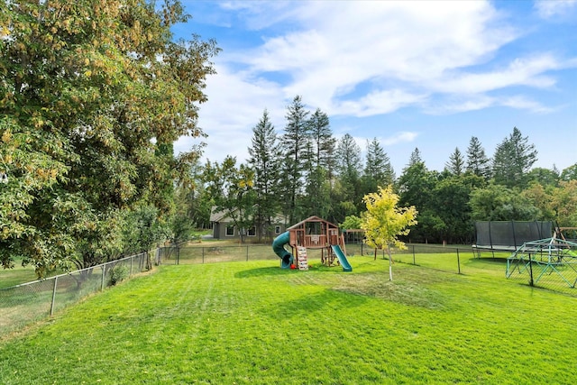 view of jungle gym featuring a fenced backyard, a trampoline, and a yard