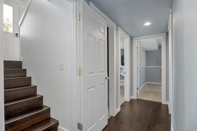 corridor with recessed lighting, stairway, baseboards, and dark wood finished floors