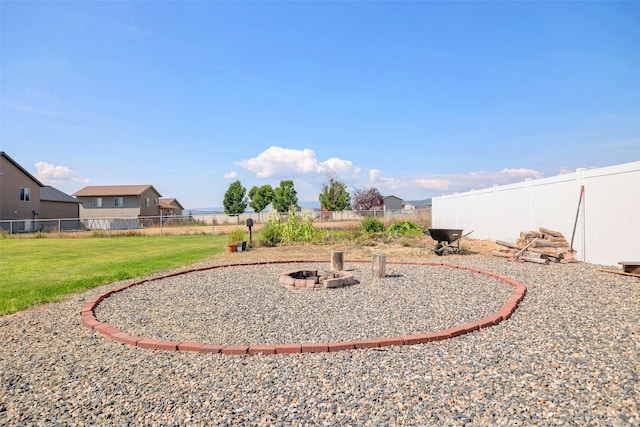 view of yard featuring a fenced backyard and an outdoor fire pit