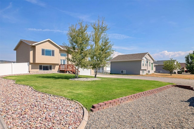 back of house with fence, a lawn, and driveway