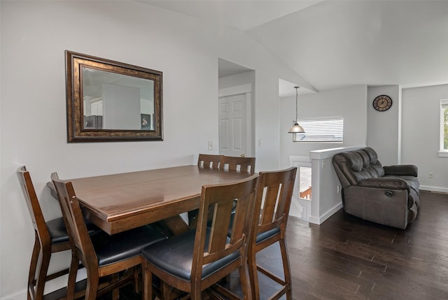 dining space with dark wood finished floors, a healthy amount of sunlight, baseboards, and lofted ceiling