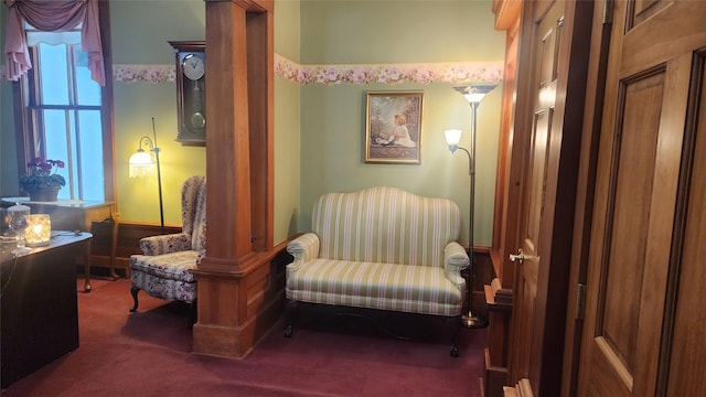 sitting room featuring dark colored carpet