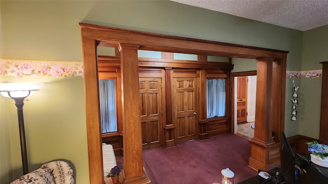 bedroom with dark carpet and a textured ceiling