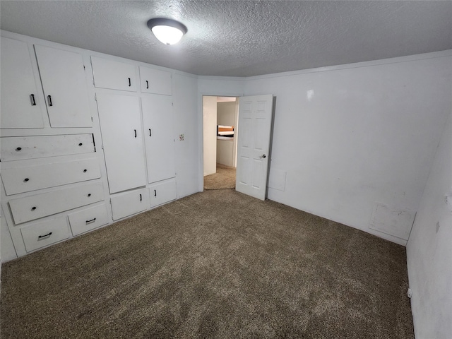 unfurnished bedroom with carpet flooring and a textured ceiling