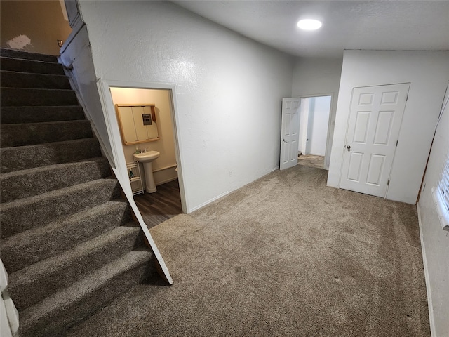 interior space featuring sink and vaulted ceiling