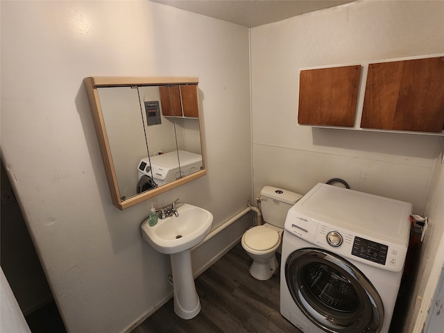 bathroom with washer / dryer, toilet, and hardwood / wood-style floors