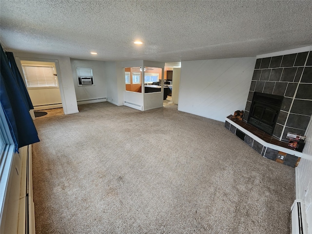 unfurnished living room featuring a textured ceiling, a baseboard radiator, a fireplace, and carpet floors