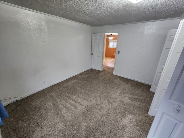 carpeted empty room featuring ornamental molding, a textured ceiling, and ceiling fan