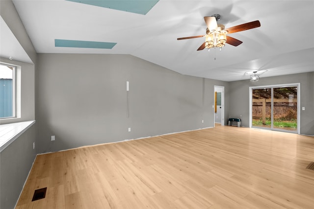 living area featuring hardwood / wood-style floors, ceiling fan, and lofted ceiling