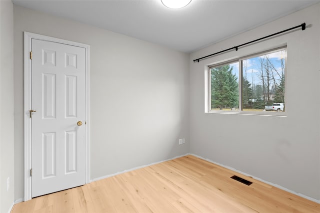 hallway featuring light hardwood / wood-style flooring and vaulted ceiling