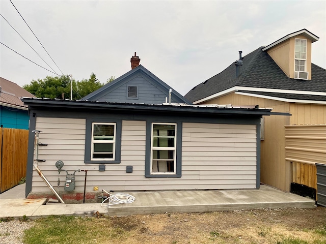 rear view of house featuring cooling unit