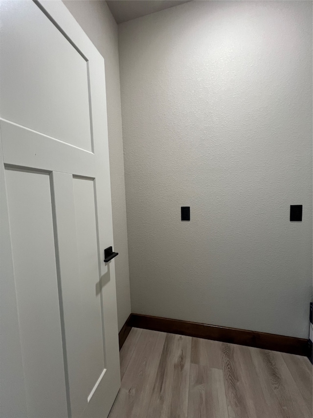 laundry area featuring light hardwood / wood-style floors