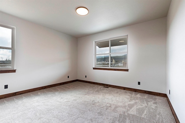 spare room with carpet flooring and baseboards