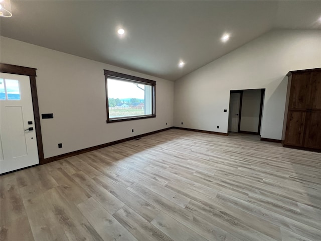 interior space with lofted ceiling and light hardwood / wood-style floors