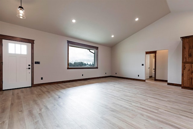 interior space with high vaulted ceiling, recessed lighting, light wood-style flooring, and baseboards