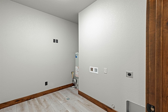 laundry area featuring laundry area, baseboards, hookup for a washing machine, hookup for an electric dryer, and light wood-type flooring