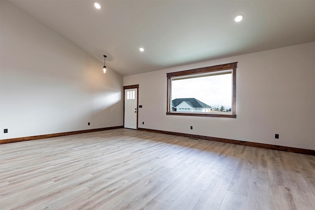 unfurnished room featuring high vaulted ceiling, recessed lighting, light wood-style flooring, and baseboards