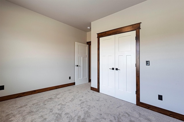 unfurnished bedroom with carpet and baseboards