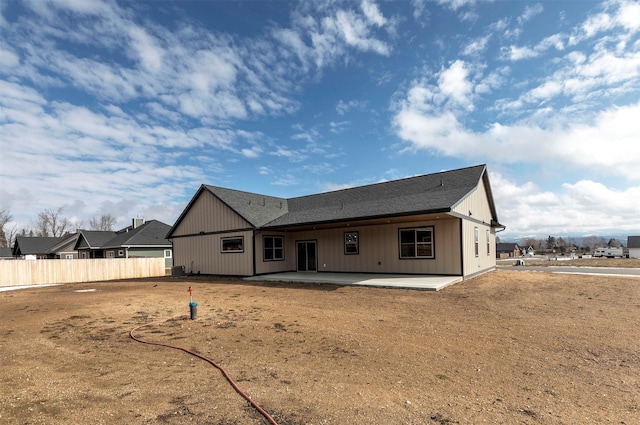 rear view of property featuring fence and a patio