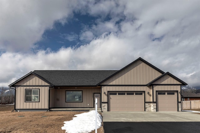 view of front of property with driveway, a shingled roof, board and batten siding, and an attached garage