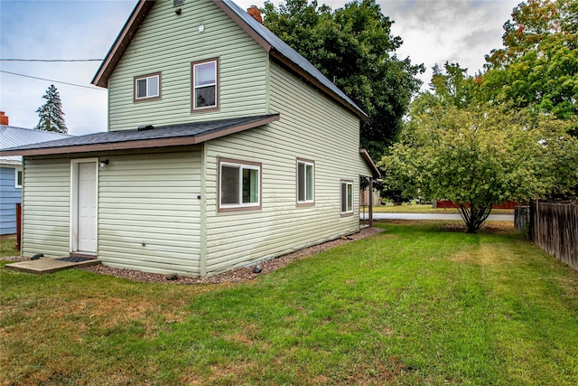 rear view of house with a lawn