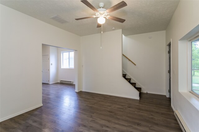 unfurnished room with a baseboard heating unit, a textured ceiling, ceiling fan, and dark hardwood / wood-style floors