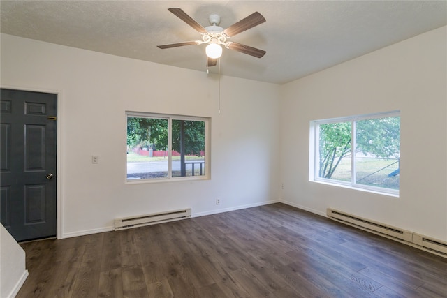 spare room featuring a baseboard heating unit, ceiling fan, dark hardwood / wood-style flooring, and a textured ceiling