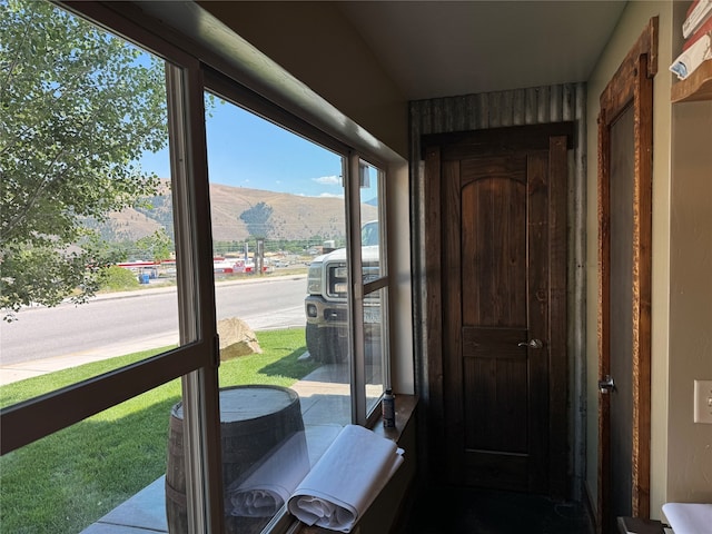 sunroom / solarium featuring a mountain view