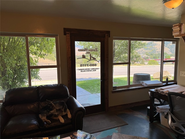 doorway to outside with concrete floors and a textured ceiling