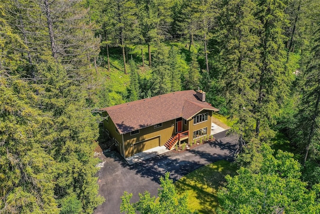 birds eye view of property featuring a view of trees